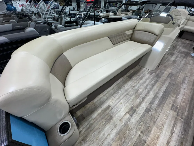 Slide: The Image of Luxurious seating on 2019 Crest III 240 SLE pontoon boat, featuring beige upholstery and wood flooring. - 23