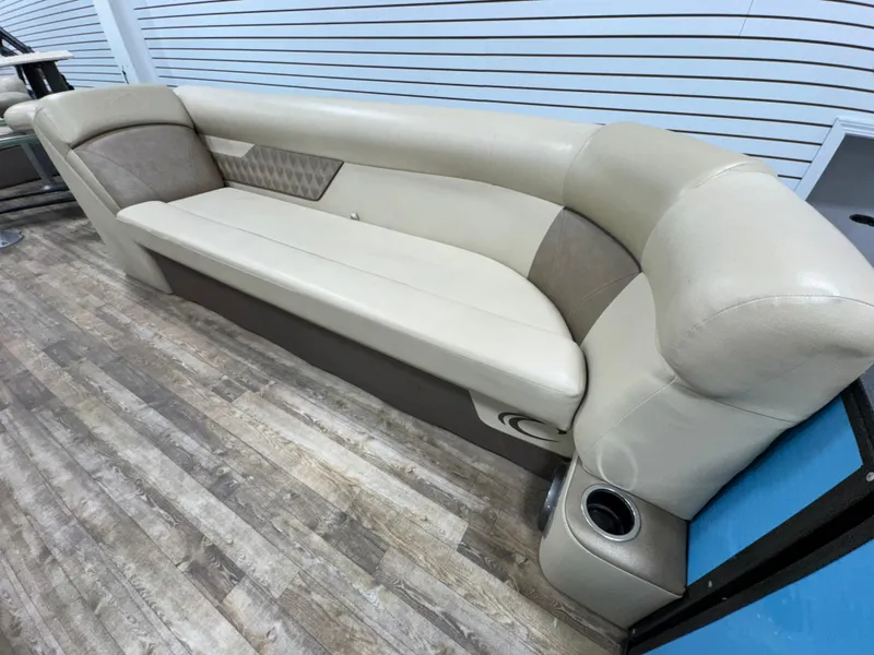 Slide: The Image of 2019 Crest III 240 SLE boat interior with beige seating and cup holders. - 24