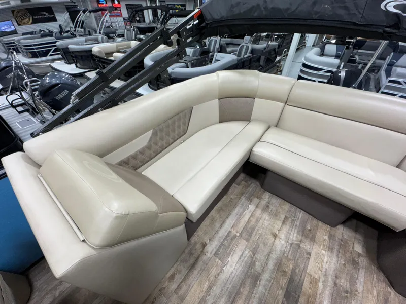 Slide: The Image of Luxurious seating on 2019 Crest III 240 SLE pontoon boat, featuring beige upholstery and spacious layout. - 25