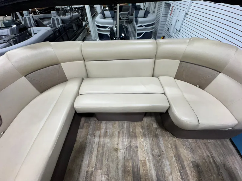 Slide: The Image of 2019 Crest III 240 SLE pontoon boat interior with beige seating and wood flooring. - 26