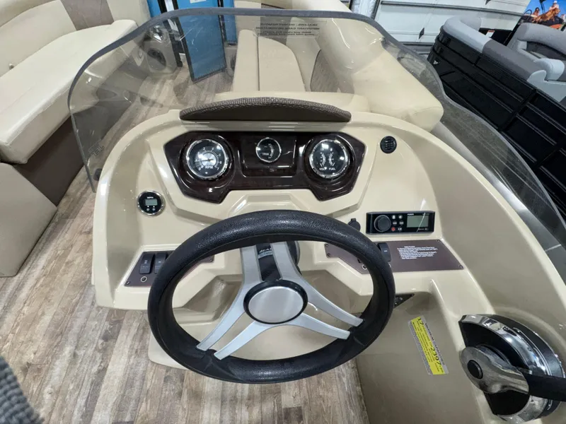 Slide: The Image of 2019 Crest III 240 SLE boat dashboard with steering wheel and gauges. - 33