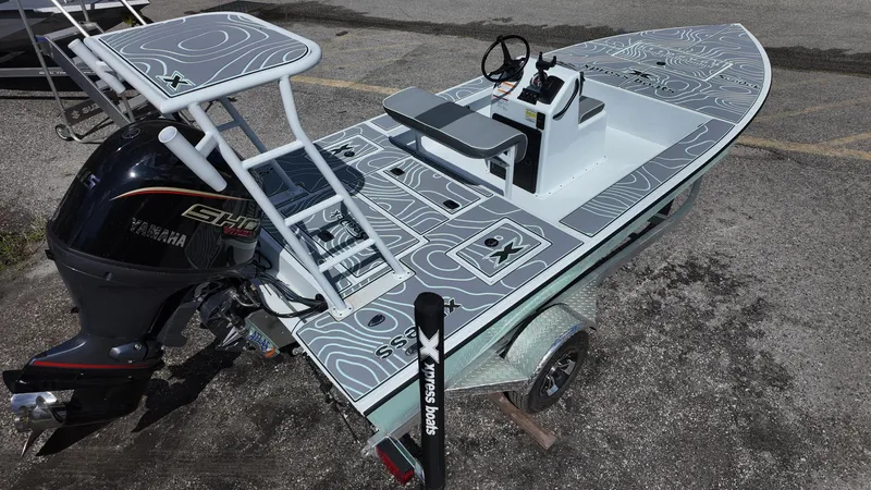 Slide: The Image of 2025 Xpress Skiff 185 boat with Yamaha engine, featuring a sleek design and modern deck layout. - 17