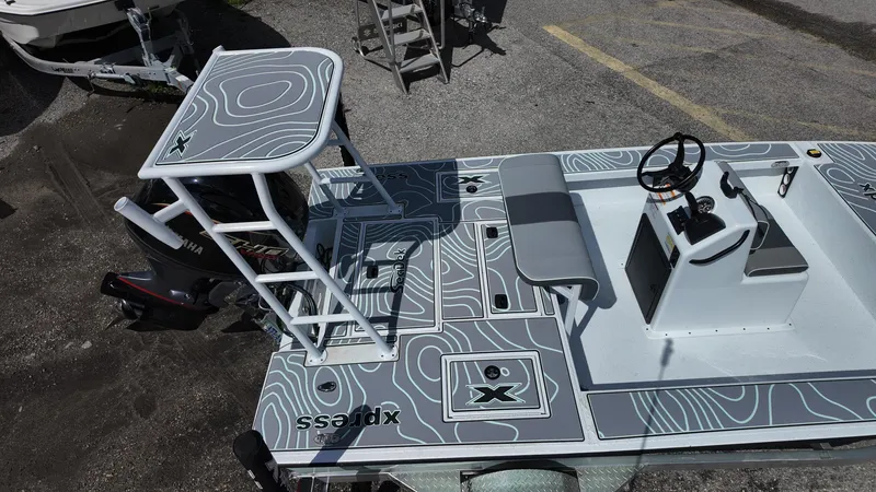 Slide: The Image of 2025 Xpress Skiff 185 boat with modern design and spacious deck layout. - 19