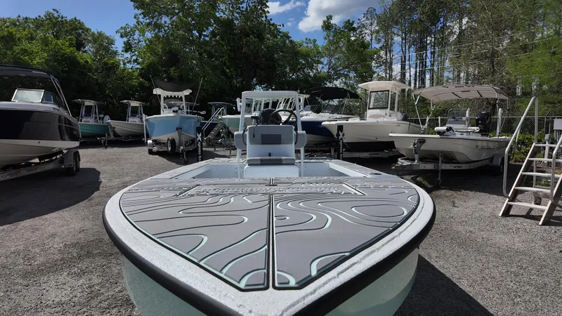 Slide: The Image of 2025 Xpress Skiff 185 boat displayed among other boats in a marina setting. - 24