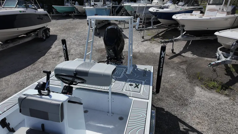 Slide: The Image of 2025 Xpress Skiff 185 boat in a marina, surrounded by other boats. - 27
