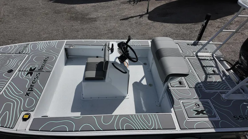 Slide: The Image of 2025 Xpress Skiff 185 boat interior with steering console and seating. - 28