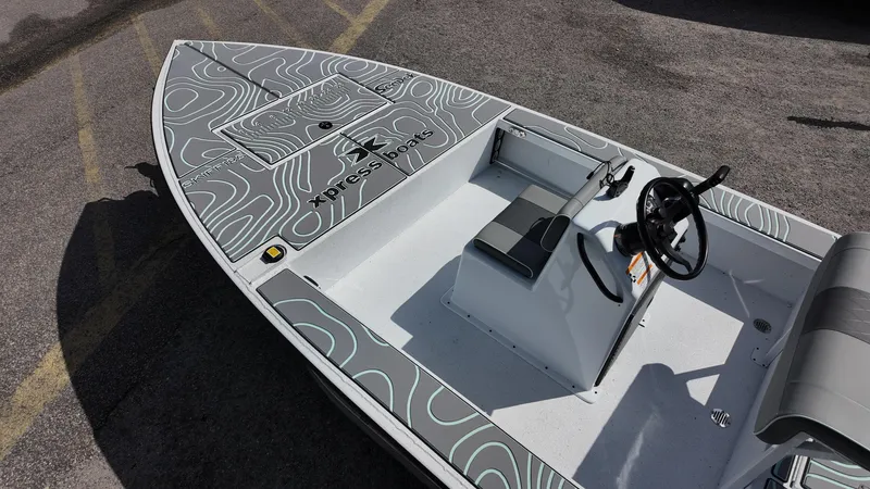 Slide: The Image of 2025 Xpress Skiff 185 boat with sleek design and modern steering console. - 29