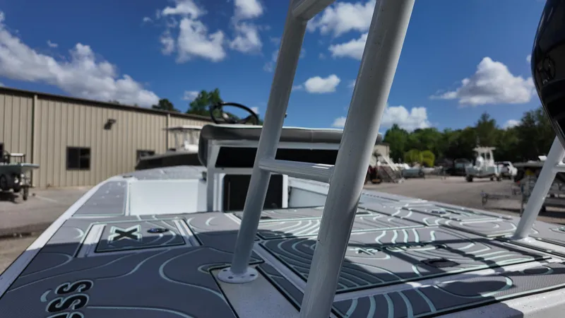 Slide: The Image of 2025 Xpress Skiff 185 boat deck under blue sky with clouds. - 30