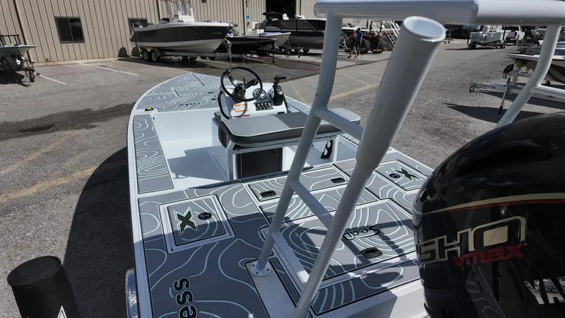 Slide: The Image of 2025 Xpress Skiff 185 boat with modern design and Yamaha engine in a marina setting. - 31