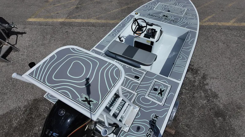 Slide: The Image of 2025 Xpress Skiff 185 boat with custom topographic design and modern console. - 34