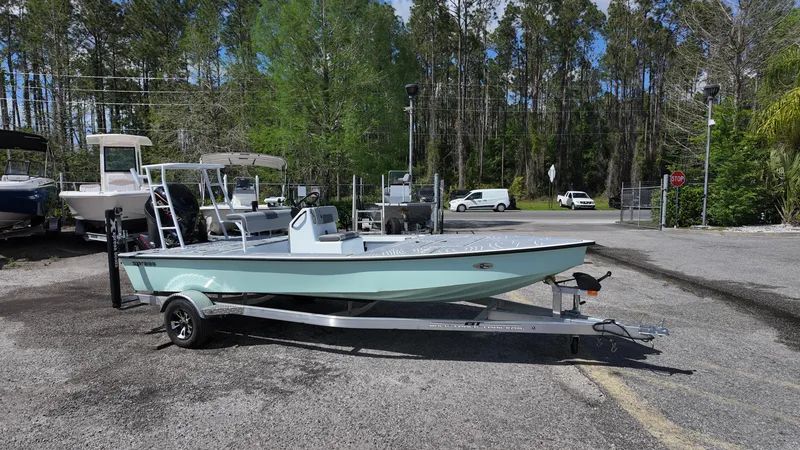 Slide: The Image of 2025 Xpress Skiff 185 boat on trailer in outdoor setting. - 4