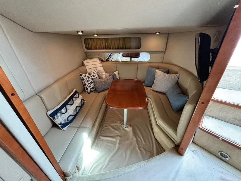 Slide: The Image of 2004 Chaparral 350 Signature cabin with cozy seating and wooden table. - 12