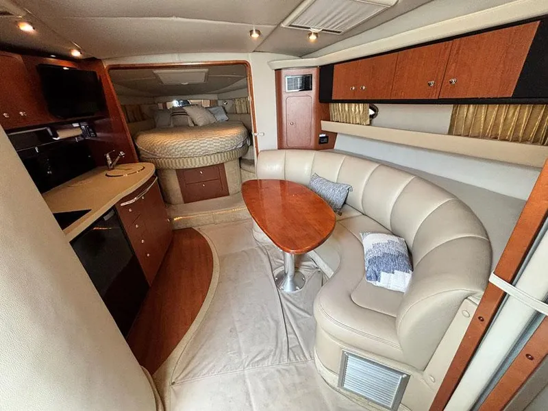 Slide: The Image of 2004 Chaparral 350 Signature yacht interior with kitchen, seating, and bed. - 13