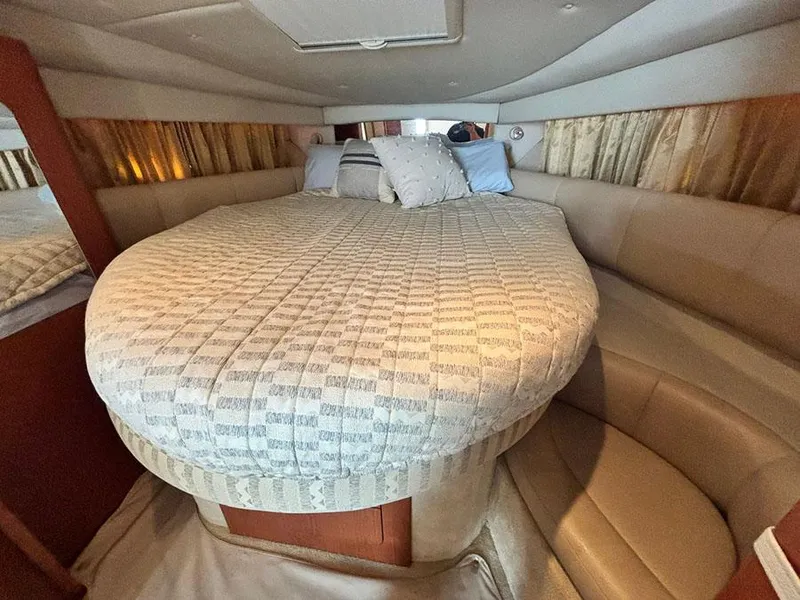 Slide: The Image of 2004 Chaparral 350 Signature cabin with cozy bed and pillows, featuring elegant interior design. - 21