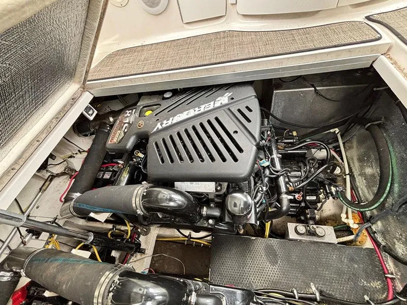 Slide: The Image of Engine compartment of a 2004 Chaparral 350 Signature boat, featuring a MerCruiser engine. - 23