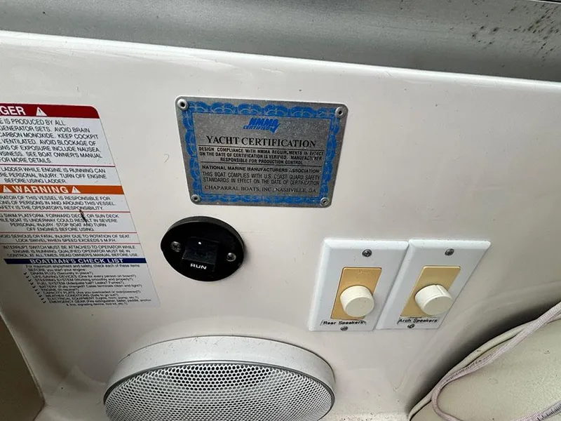 Slide: The Image of 2004 Chaparral 350 Signature yacht certification and control panel with safety warnings. - 7