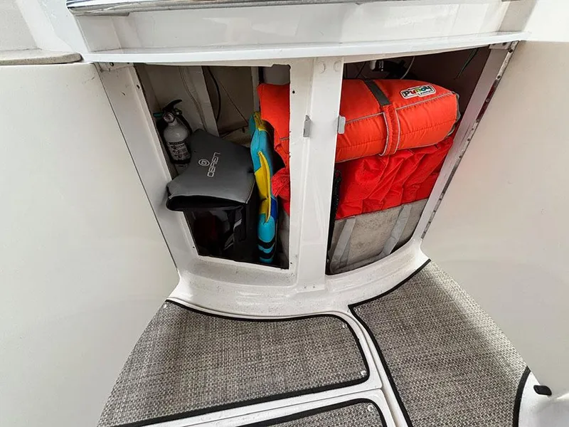 Slide: The Image of Storage compartment on a 2004 Chaparral 350 Signature boat with life jackets and equipment. - 9