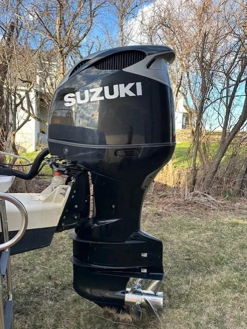 Slide: The Image of 2008 Grady-White Gulfstream 232 with Suzuki outboard motor in a grassy yard. - 3