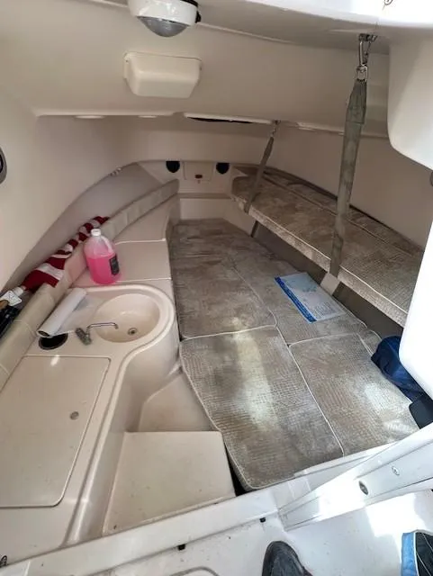 Slide: The Image of 2008 Grady-White Gulfstream 232 cabin interior with seating and sink. - 5