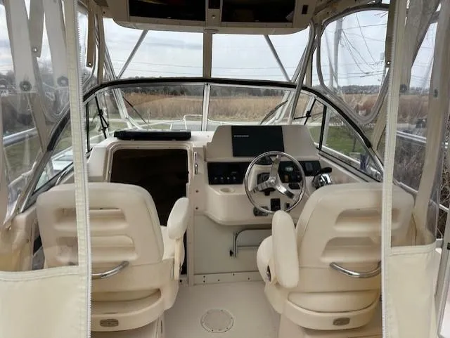 Slide: The Image of 2008 Grady-White Gulfstream 232 boat interior with dual seats and steering console. - 9