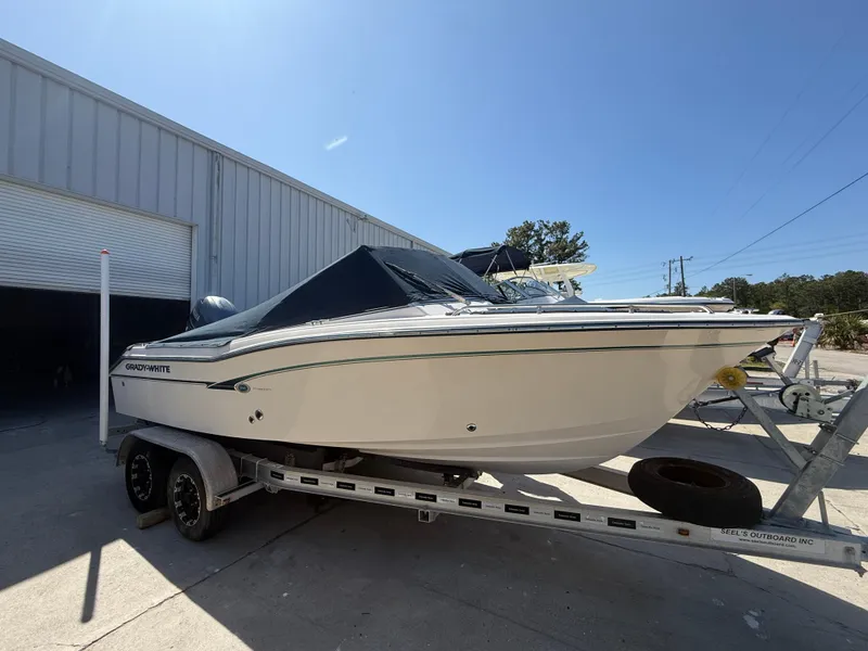 Slide: The Image of 2011 Grady-White Freedom 192 boat on trailer, parked outside a warehouse. - 12