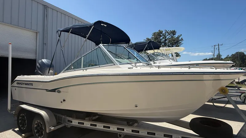 Slide: The Image of 2011 Grady-White Freedom 192 boat on trailer, parked outdoors. - 17