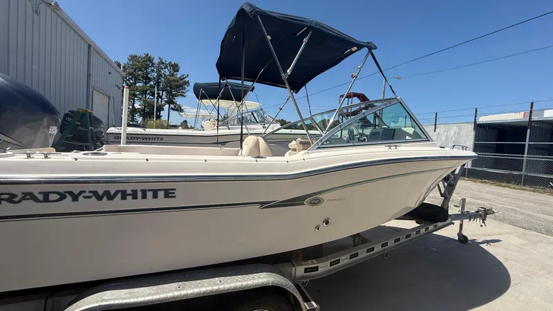 Slide: The Image of 2011 Grady-White Freedom 192 boat on trailer with canopy, parked outdoors. - 18