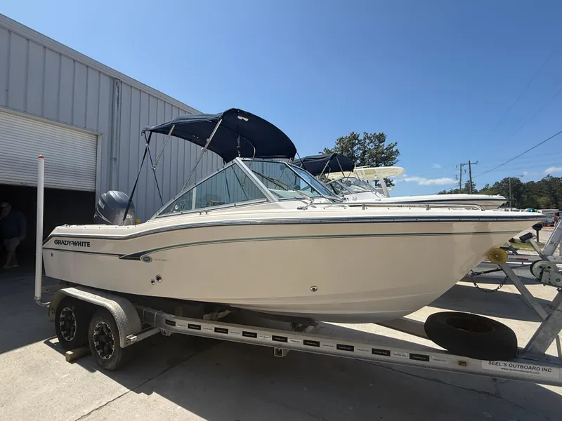 Slide: The Image of 2011 Grady-White Freedom 192 boat on trailer, parked outside a warehouse. - 20