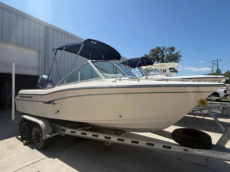 Slide: The Image of 2011 Grady-White Freedom 192 boat on trailer, parked outdoors under clear sky. - 21