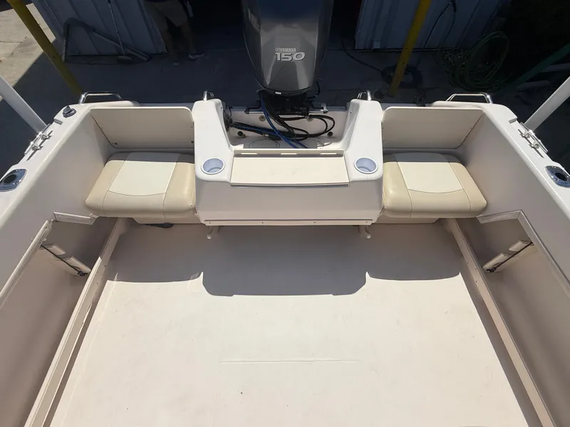 Slide: The Image of 2011 Grady-White Freedom 192 boat interior with seating and motor. - 23