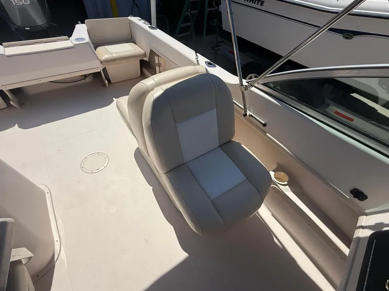 Slide: The Image of 2011 Grady-White Freedom 192 boat interior with cushioned seating and cup holder. - 24