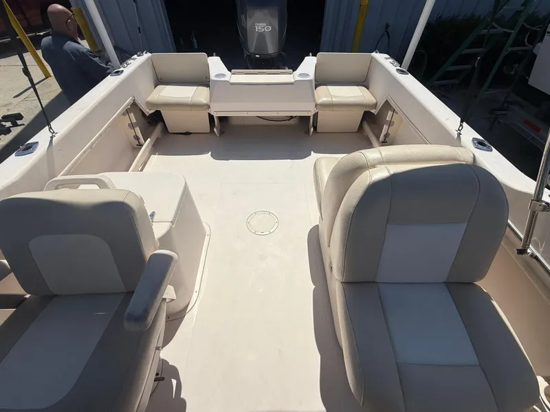 Slide: The Image of 2011 Grady-White Freedom 192 boat interior with seating and motor, viewed from above. - 25