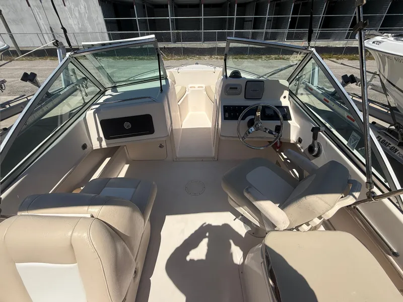 Slide: The Image of 2011 Grady-White Freedom 192 boat interior with beige seating and steering console. - 36