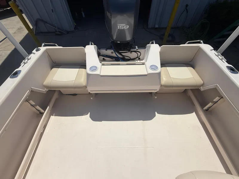 Slide: The Image of 2011 Grady-White Freedom 192 boat interior with Yamaha 150 engine, beige seating. - 38