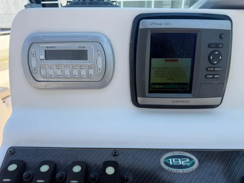 Slide: The Image of 2011 Grady-White Freedom 192 dashboard with Garmin GPS and marine stereo system. - 41