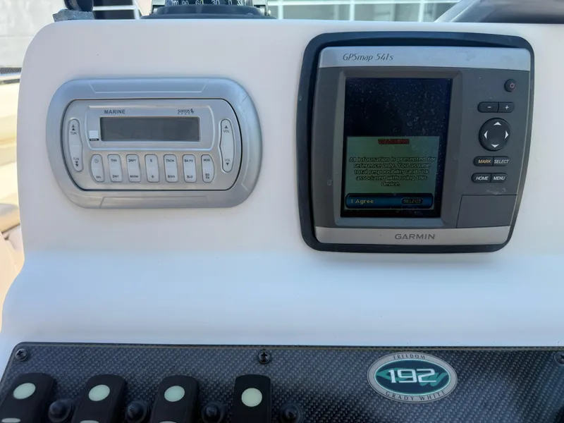 Slide: The Image of Control panel of 2011 Grady-White Freedom 192 with Garmin GPS and marine stereo. - 42