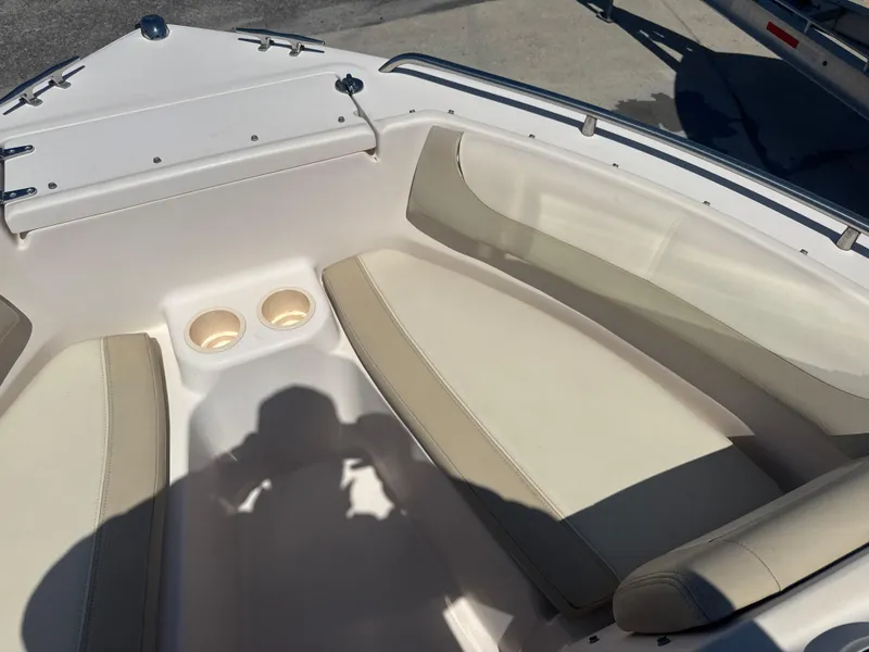 Slide: The Image of 2011 Grady-White Freedom 192 boat interior with beige seating and cup holders. - 45
