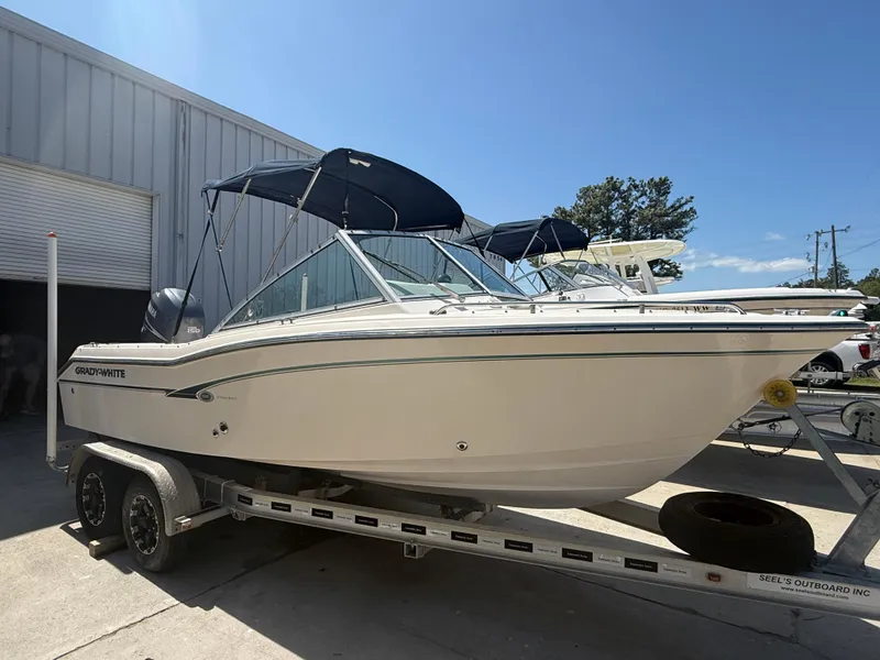 Slide: The Image of 2011 Grady-White Freedom 192 boat on trailer, parked outdoors under clear sky. - 5