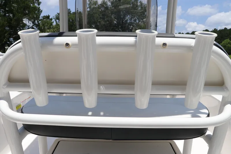 Slide: The Image of 2025 Robalo 206 Cayman boat rod holders, white, sunny day, outdoor setting. - 12