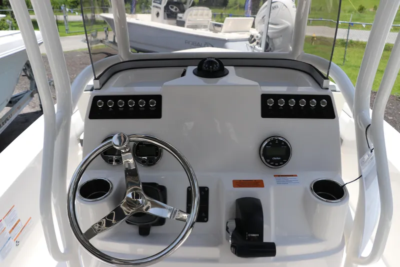 Slide: The Image of 2025 Robalo 206 Cayman boat dashboard with steering wheel and controls. - 15