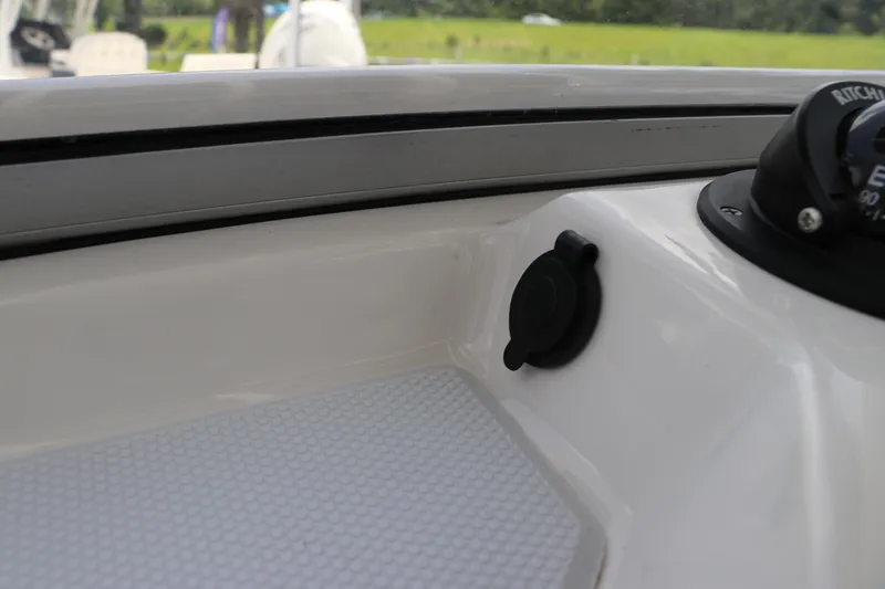 Slide: The Image of 2025 Robalo 206 Cayman boat interior with compass and plug socket. - 17