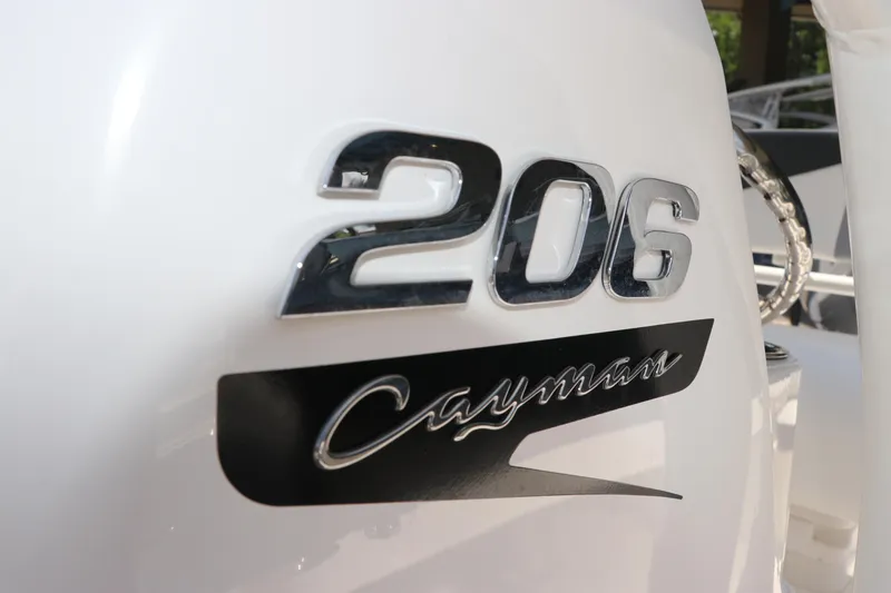 Slide: The Image of Close-up of 2025 Robalo 206 Cayman boat logo on white surface. - 21