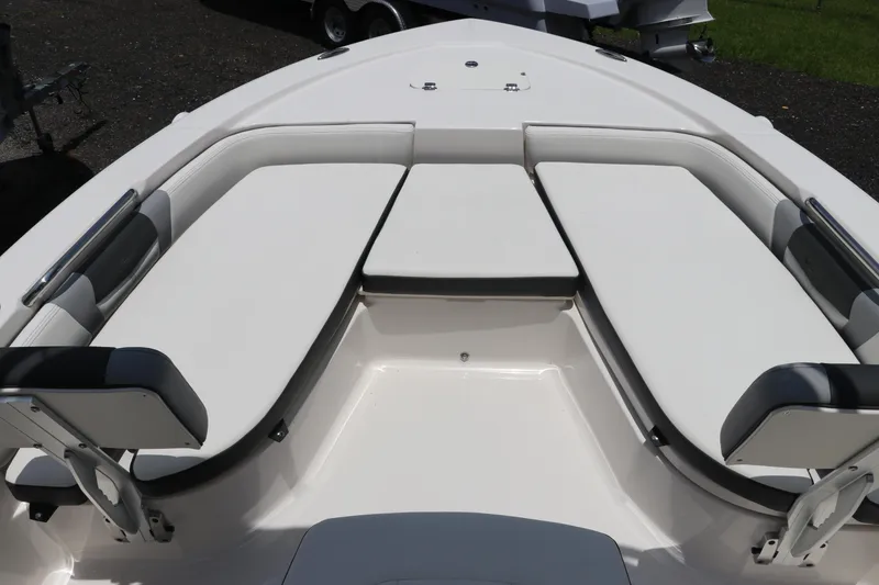 Slide: The Image of 2025 Robalo 206 Cayman boat interior with cushioned seating and sleek design. - 23