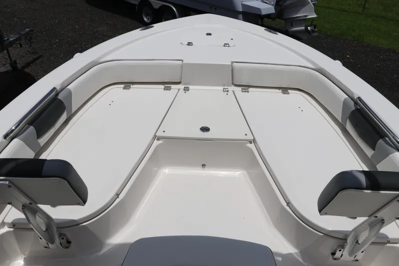 Slide: The Image of 2025 Robalo 206 Cayman boat interior with cushioned seating and storage compartments. - 24