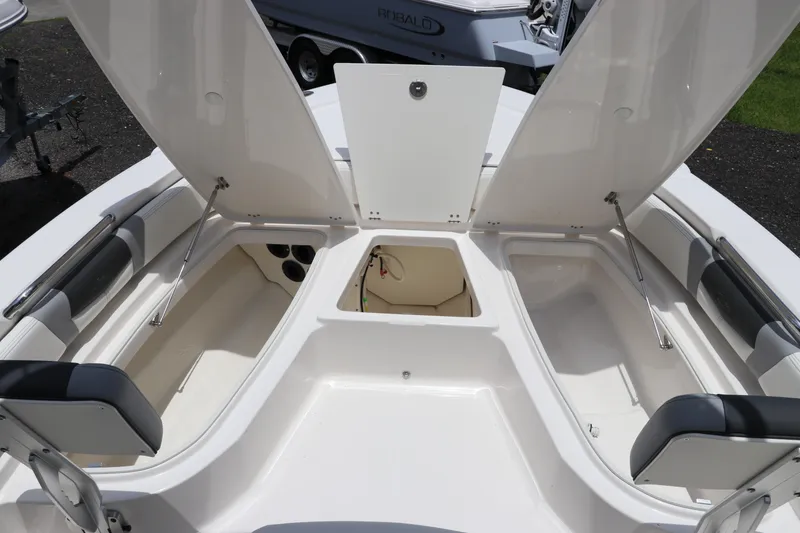 Slide: The Image of 2025 Robalo 206 Cayman boat storage compartments open, showcasing spacious interior design. - 25
