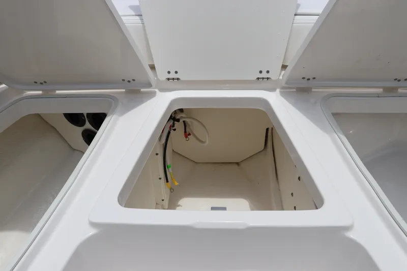 Slide: The Image of Open storage compartments on a 2025 Robalo 206 Cayman boat. - 28