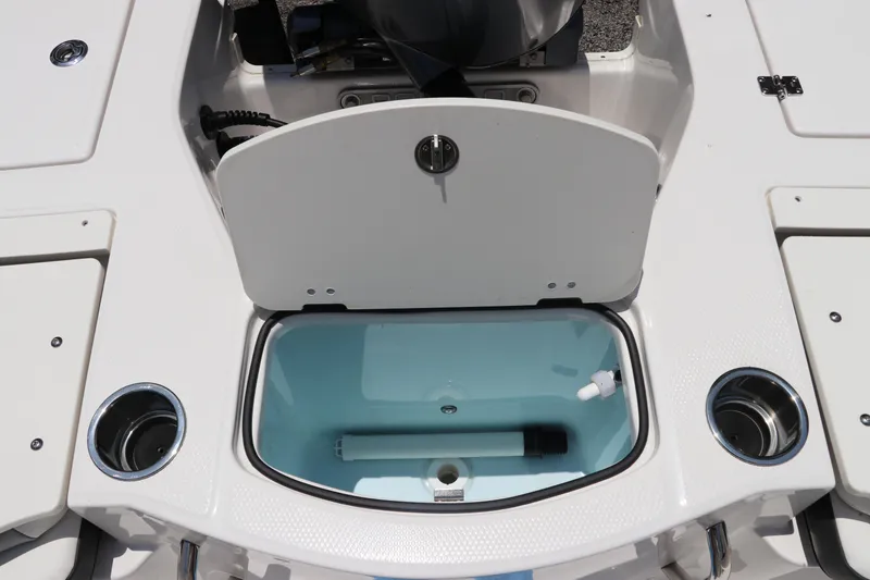 Slide: The Image of 2025 Robalo 206 Cayman boat livewell with open lid and cup holders. - 8