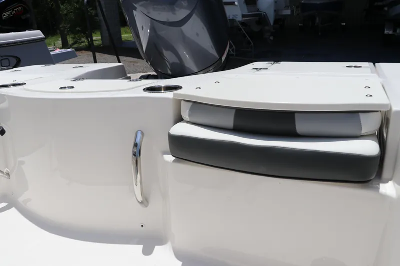 Slide: The Image of 2025 Robalo 206 Cayman boat interior with cushioned seating and stainless steel handle. - 9