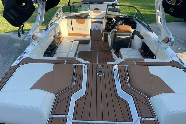Slide: The Image of 2017 Correct Craft Super Air Nautique GS interior with brown and white seating. - 11