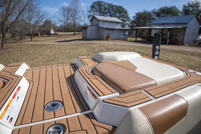 Slide: The Image of 2017 Correct Craft Super Air Nautique GS boat with teak deck, rural background. - 12